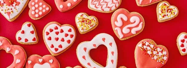 Glazed heart shape cookies isolated on red