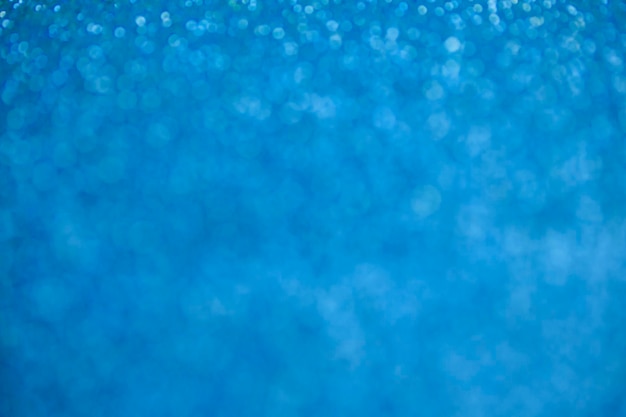 Glitter blue background texture foil and confetti bokeh light of blue dust festive party christmas