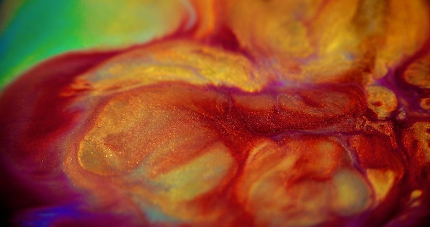 Glitter fluid spill shiny paint blur red yellow purple green color golden sparkle grain particles