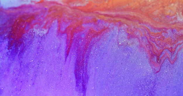 Glitter fluid Wet ink texture Shiny liquid mix Defocused purple red orange color shimmering paint drip flow abstract art background