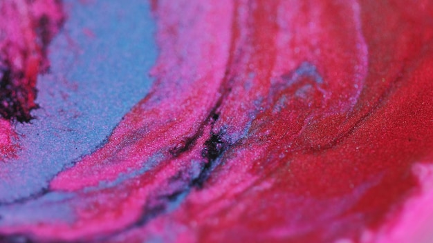 Glitter ink wave shimmering fluid pink blue paint