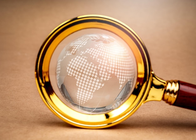 Global trends world wide customer insights digital online connection technology and business marketing web browser concept Closeup digital globe inside magnifying glass len on brown background