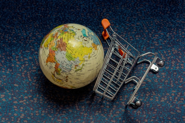 Globe and Shopping cart or shopping trolley seen as business concept