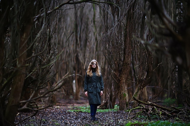 gloomy autumn park girl portrait, unusual toning autumn look model