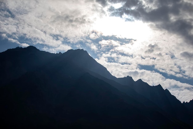 Gloomy landscape of dark mountains and cloudy sky