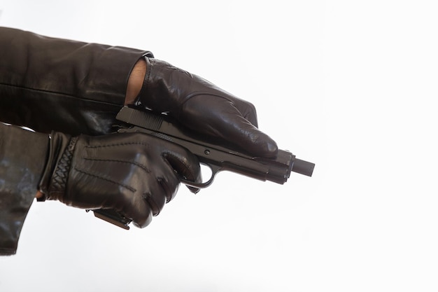 Gloved hand holding a pistol isolated on white background