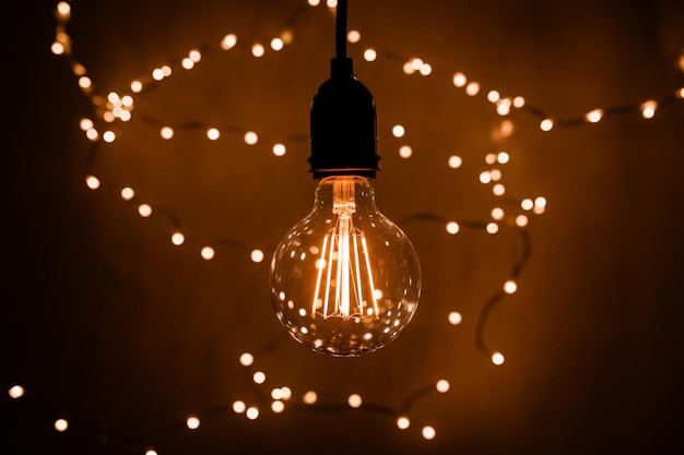 Photo glowing bulb suspended mid air surrounded by swirling lights in dark background