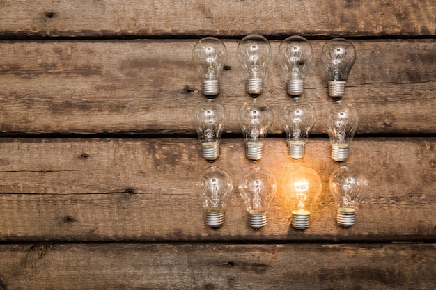 glowing bulb uniqueness concept on brown wooden table