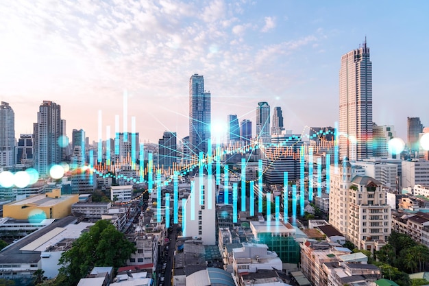 Glowing FOREX graph hologram aerial panoramic cityscape of Bangkok at sunset Stock and bond trading in Asia The concept of fund management Double exposure