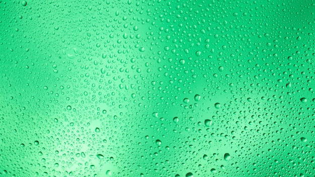 Glowing gradient green background with contrasting water drops