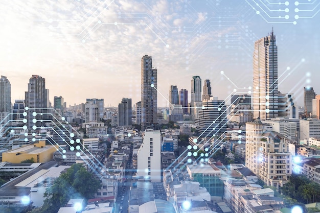 Glowing hologram of technological process aerial panoramic cityscape of Bangkok at sunset The largest innovative hub of tech services in Southeast Asia Multi exposure