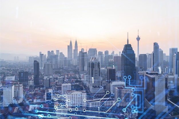 Glowing hologram of technological process aerial panoramic cityscape of Kuala Lumpur at sunset KL is the largest innovative hub of tech services in Malaysia Asia Multi exposure