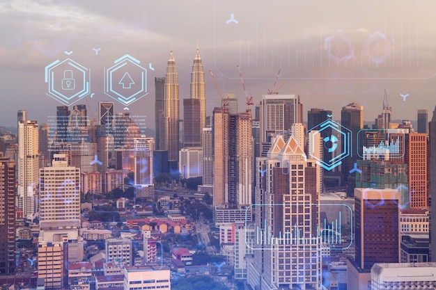 Glowing hologram of technological process aerial panoramic cityscape of Kuala Lumpur at sunset KL is the largest innovative hub of tech services in Malaysia Asia Multi exposure