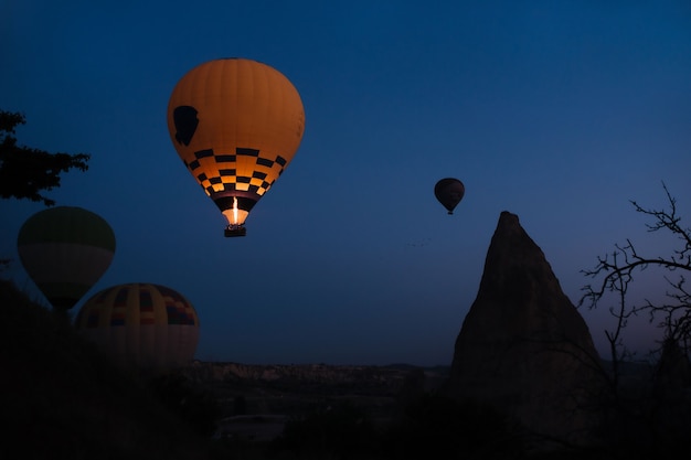 Glowing hot air balloon at dawn to gurima cappadocia