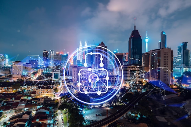 Glowing padlock hologram night panoramic city view of Kuala Lumpur Malaysia Asia The concept of cyber security shields to protect KL companies Double exposure