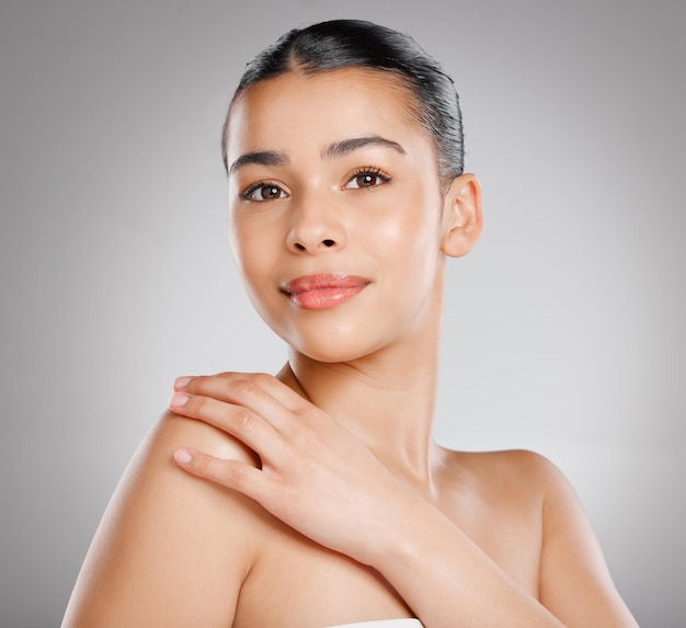 Glowing skin gives you that extra beauty boost Studio shot of an attractive young woman posing against a grey background