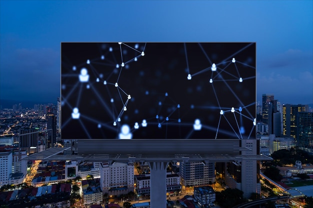 Glowing Social media icons on billboard over night panoramic city view of Kuala Lumpur Malaysia Asia The concept of networking and establishing new connections between people and businesses in KL