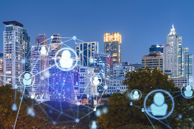 Glowing social media icons on night panoramic city view of Bangkok Southeast Asia The concept of networking and establishing new connections between people in businesses Double exposure