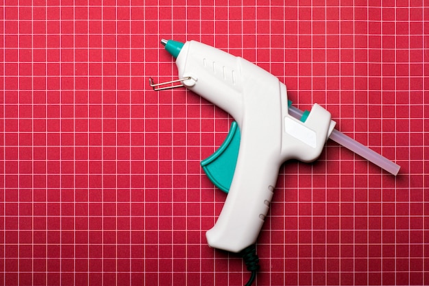 Glue gun on red surface