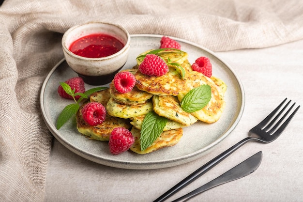 Gluten-free zucchini pancakes with raspberries and raspberry jam. Healthy food concept, summer food.