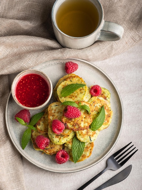 Gluten-free zucchini pancakes with raspberries and raspberry jam. Healthy food concept, summer food.