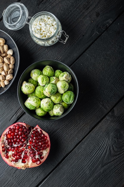 Gnarly garlic brussels ingredients on black wooden table