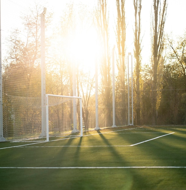 A goal gates on a football field outdoors on a summer day