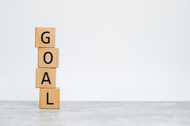 Goal word written on wood block on table. Business concept.