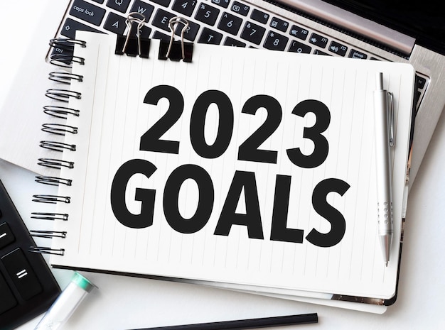 Goals 2023 on notebook with laptop and calculator