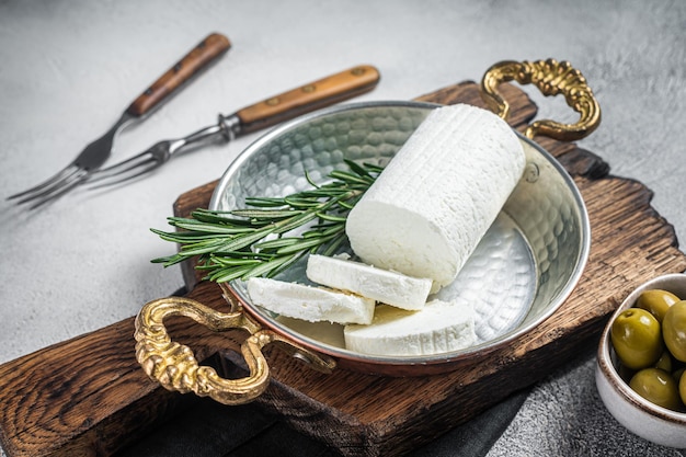 Goat soft cheese chevre in a skillet White background Top view