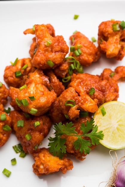 Gobi Manchurian dry - Popular street food of India made of cauliflower florets, selective focus