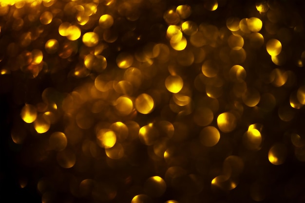 Photo gold abstract christmas bokeh on black background