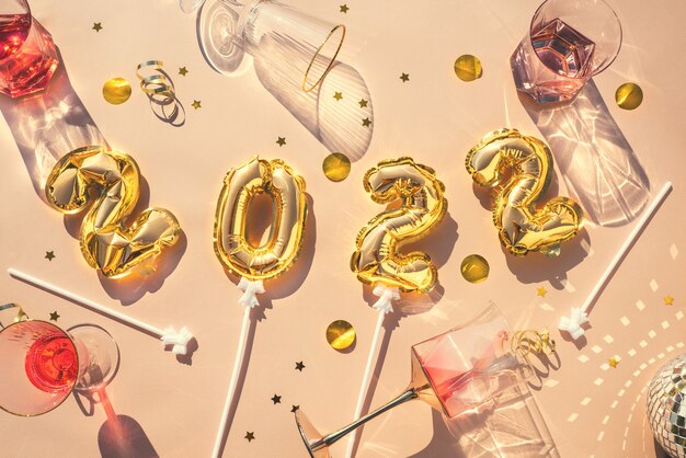 Gold balloons  champagne glasses concept fun new years party