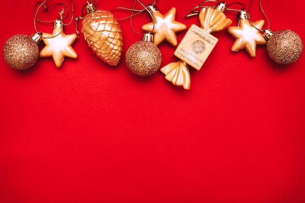 Gold Christmas balls and toys on a red background