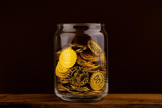 Gold coin in glass bottle on black scene money and gold saving concept