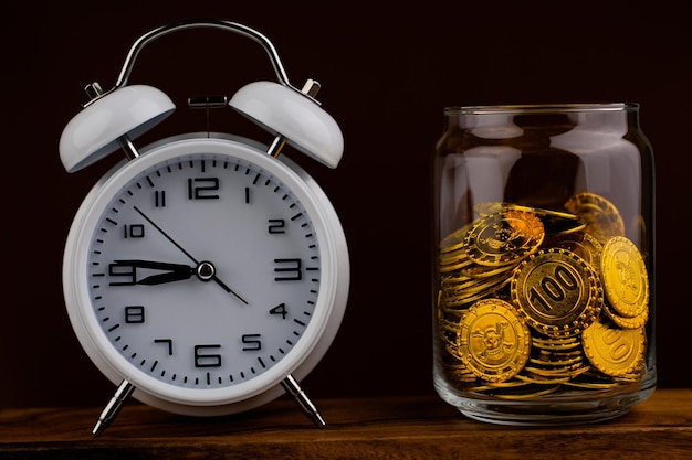 Gold coin in glass bottle on black scene money and gold saving concept