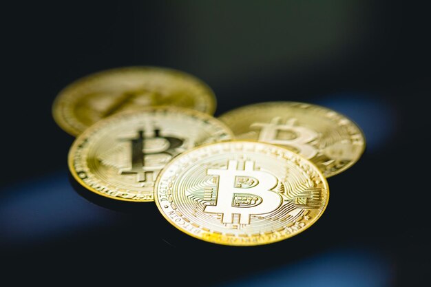 Gold coins of bitcoin on the surface of table with glass