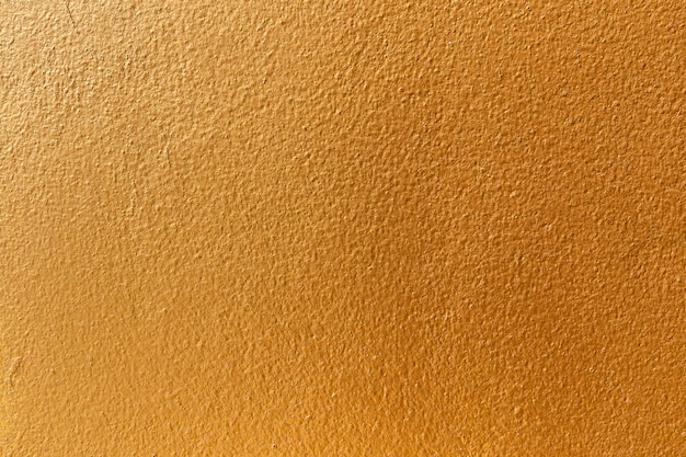 Gold color old grunge wall concrete texture as background.