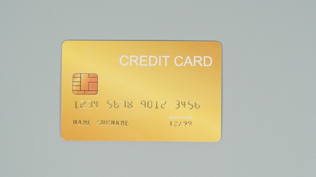 Gold credit card isolated on grey background.Nopeople.