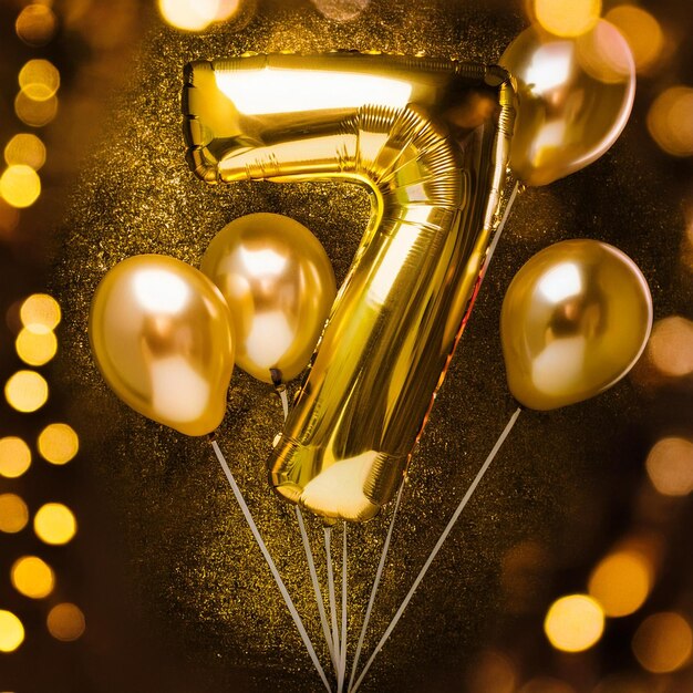 Photo gold foil balloon number seven on blue velvet birthday greeting card with inscription 7 golden num