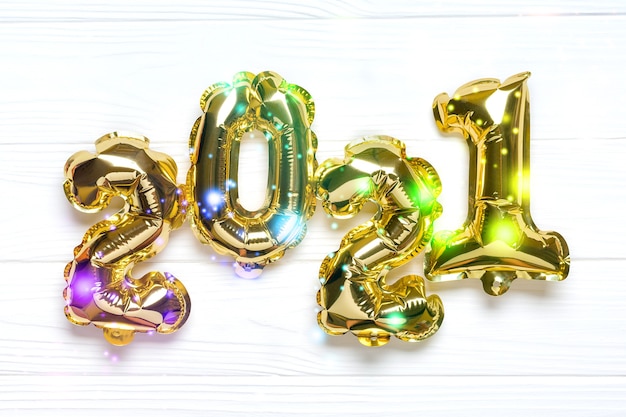 Gold foiled balloons in shape of numeral 2021 isolated