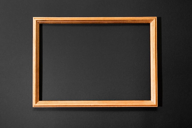 Gold frame on the black background minimalistic card with copy space for text