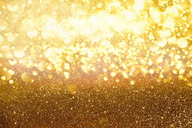 Gold glitter lights texture bokeh abstract background. defocused