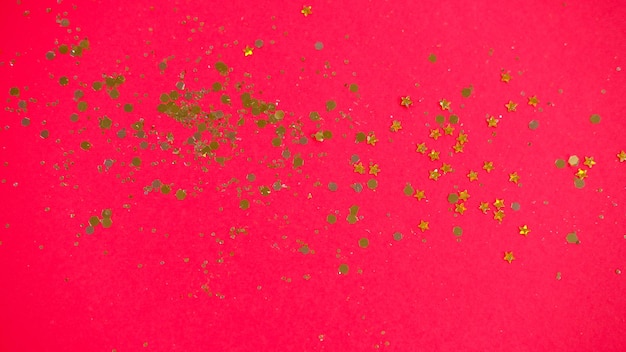 Gold glitter sparkle confetti banner on red background