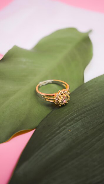 gold leaf and gem ring on pink background