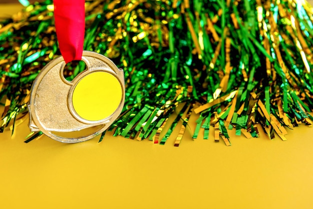 Gold medal hanging on yellow background