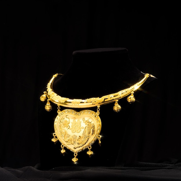 A gold necklace with a lion on it