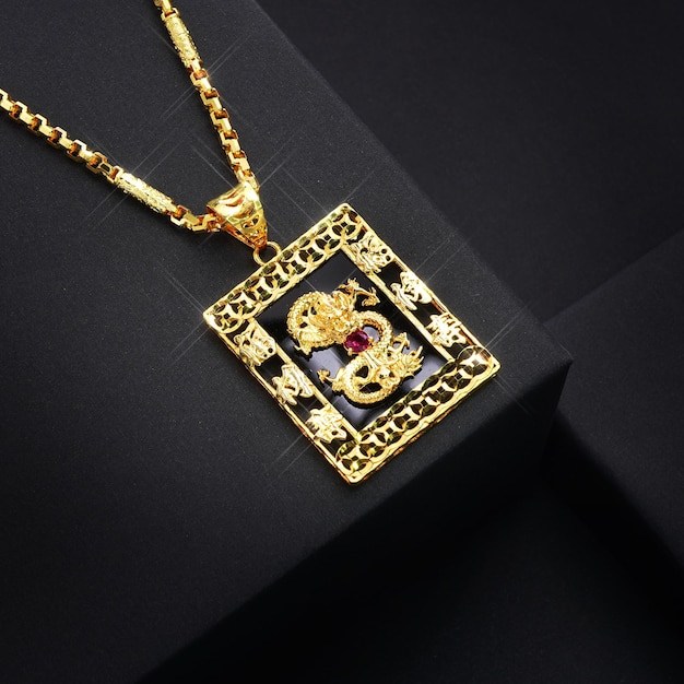 a gold necklace with a medallion design on it