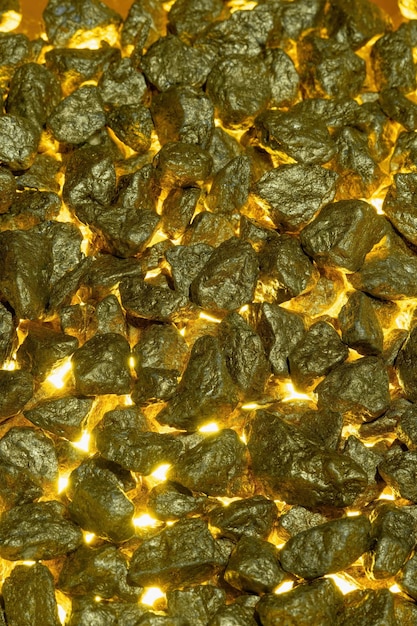 Gold nuggets as a background with golden light from below