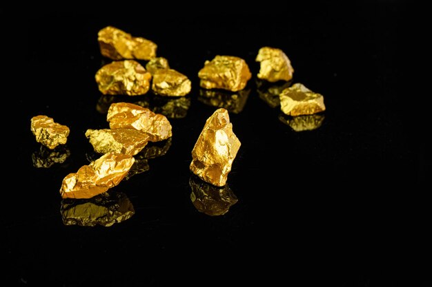 Photo gold pieces on a black background with the word gold